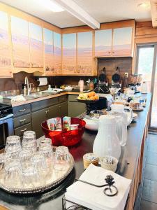 a kitchen with a counter with glasses on it at Cozy Cabin suite bed and breakfast in Woodland Park +5 photos