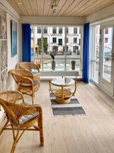 a living room with chairs and a table and a window at Guesthouse at the boat harbour in Tórshavn