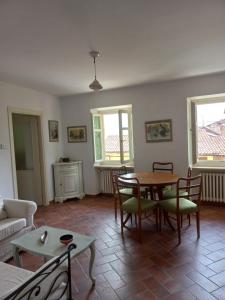 een woonkamer met een tafel en stoelen bij Il giardino di Olivia in Guarene