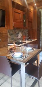 a kitchen with a wooden table with plates on it at Best House in Bormio