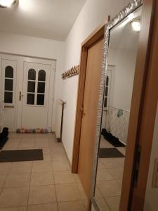 a hallway with a mirror next to a door at Casa Montana in Scheiden