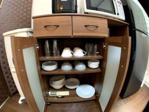 a cabinet with plates and a tv on top of it at Big stone tsukuda - Vacation STAY 14554 in Aomori