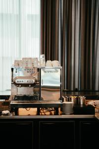 a table with a coffee maker and dishes on it at Residence Inn Ghent by Marriott in Ghent