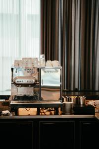 a table with a coffee maker and dishes on it at Residence Inn by Marriott Ghent in Ghent