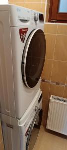 a washer and dryer sitting in a bathroom at Blue Home in Balatonföldvár