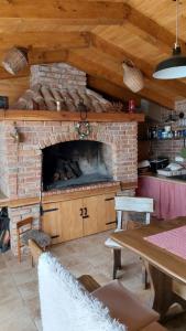 a kitchen with a brick fireplace with a table and a table sidx sidx at Karlo1 Apartment in Senj