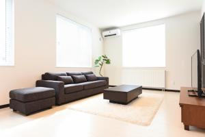 a living room with a couch and a coffee table at Sapporo - House - Vacation STAY 14578 in Sapporo