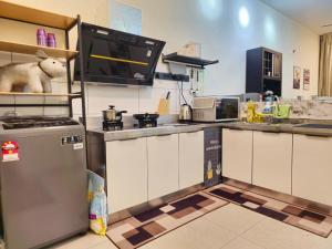 a kitchen with a refrigerator and a counter top at 1 Dream Home @ Canopy Hills 2房1厕完美与齐全设备10分钟到达 UKM in Kajang