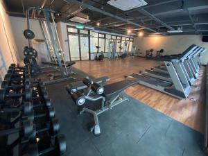 a gym with several treadmills and machines in a room at 1 Dream Home @ Canopy Hills 2房1厕完美与齐全设备10分钟到达 UKM in Kajang