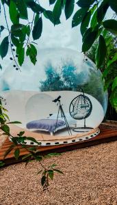 a glass bowl with a bed in it on a table at W BAŃCE Glamping in Łódź