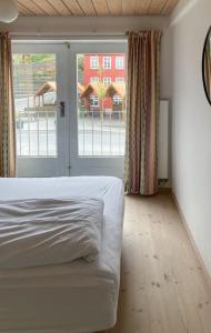 a bedroom with a bed and a large window at Guesthouse at the boat harbour in Tórshavn