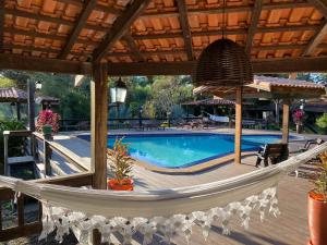 a hammock in front of a swimming pool at Hotel Santa Esmeralda in Bonito