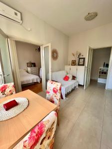 a living room with two beds and a table and chairs at Mint Apartment in Tivat