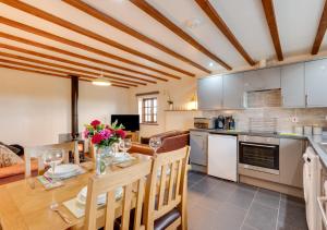 a kitchen and dining room with a table and chairs at Y Beudy in Y Felinheli
