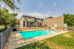 a swimming pool in the backyard of a house at Tripleg Apartments 1 in Fourways