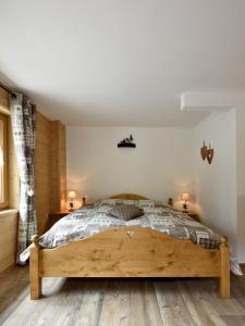 a bedroom with a large wooden bed in a room at Hotel Les Mélèzes in Haudères