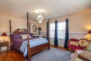 a bedroom with a canopy bed and a window at HISTORICAL JOHN RAST HOUSE circa 1875 in Roseburg