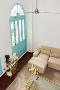 a living room with a couch and a blue door at Best location - Luxury and charming loft in Panama City