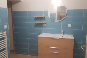 a bathroom with a sink and a mirror at La MAISON BLEUE, Smeg Bleu azur in Évian-les-Bains