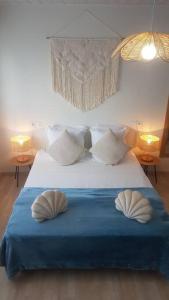 a bedroom with a bed with two pillows on it at La MAISON BLEUE, Smeg Bleu azur in Évian-les-Bains
