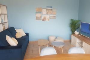 a living room with a blue couch and a table at La MAISON BLEUE, Smeg Bleu azur in Évian-les-Bains +36 photos