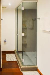 a shower with a glass door in a bathroom at Best location - Luxury and charming loft in Panama City