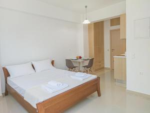 a bedroom with a bed and a table with towels on it at Fully renovated Studio in Platanias in Plataniás