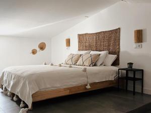 a bedroom with a large bed with a wooden headboard at La Morica in Gelsa