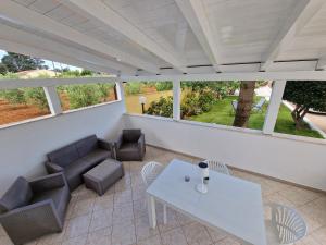 a balcony with a white table and chairs at Meraviglia d'Otranto in Otranto