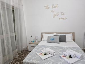 a bedroom with a bed with towels on it at Meraviglia d'Otranto in Otranto