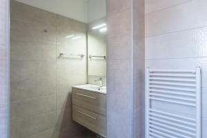 a bathroom with a sink and a mirror at Olive Hill Apartment in Portorož +4 photos