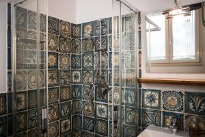 a bathroom with a tiled wall and a window at Tenuta Valdelmelo in Castiglione della Pescaia +73 photos