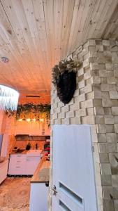 a kitchen with a white refrigerator and a stone wall at The Stable House in Bucharest