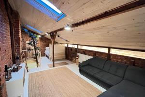 a living room with a couch and a brick wall at The Stable House in Bucharest