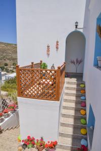 a stairway with colorful pots and flowers on it at nikola's house in Adamas