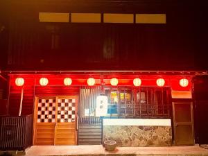 a restaurant with red lights on the front of it at Kominka Dining Bar Yumeyashiki- Vacation STAY 50909v in Karatsu