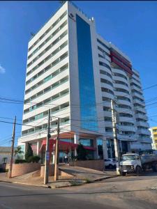 a large building with a truck parked in front of it at Apartamento West Flat in Mossoró