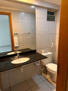 a bathroom with a sink and a toilet at Apartamento West Flat AP213 in Mossoró