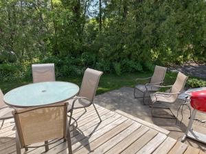 a patio with a table and chairs on a deck at Parkside Inn in Ellison Bay