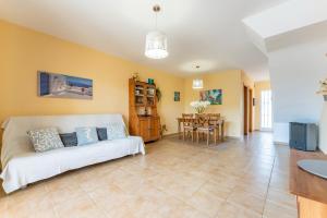 a living room with a couch and a table at Miami Platja Casa LOGA in Miami Platja