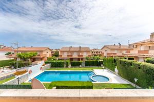 a swimming pool in a yard with houses at Miami Platja Casa LOGA in Miami Platja