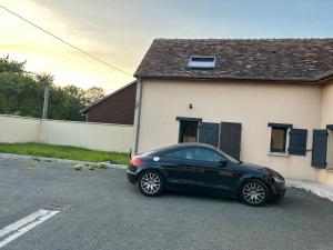 a black car parked in front of a house at Marwan in Sargé Les Le Mans 