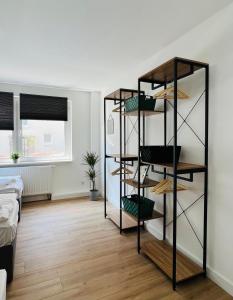 Zimmer mit Regalen in einem Zimmer mit Bett in der Unterkunft Sali - R1 - Apartmenthaus, WLAN, TV in Remscheid