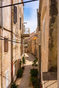 an alley in an old town with buildings at Apartment Rose in Korčula