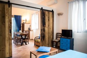 a room with a bed and a table with a tv at Tenuta Valdelmelo in Castiglione della Pescaia