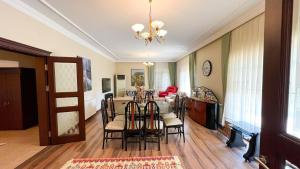 a dining room and living room with a table and chairs at Heaven White Palace in Bostancı