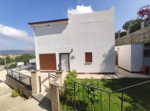 a white house with a balcony with a fence at Denizolgun Homes Eska Villa 1+1 in Dalaman