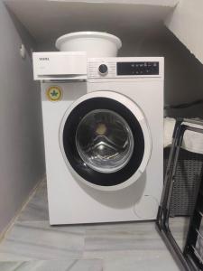 a white washing machine with a bowl on top of it at Denizolgun Homes Eska Villa 1+1 in Dalaman