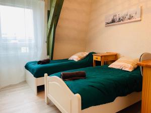 Posteľ alebo postele v izbe v ubytovaní Appart Cosy 2 chambres
