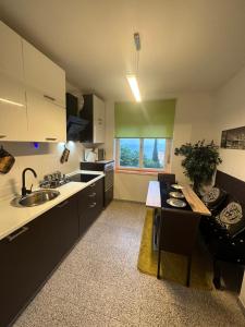 a kitchen with a sink and a table in it at Apartment Tony 55m2 in Opatija +5 photos